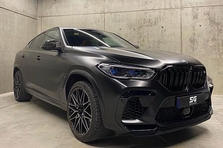 Luxury BMW X6 Transfers in San Juan with Champagne and Insider Tips