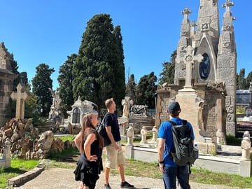 Tour guide explaining the history of the montjuic cemetery, graves, and the people buried there