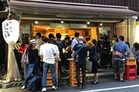 A raucous standing bar in Akabane.