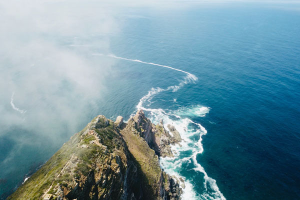 Breathtaking coastal views of the Cape Peninsula, Table Mountain, and vineyards.