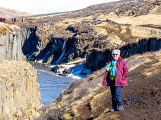 Reflections ripple in the turquoise waters beneath ancient basalt walls.