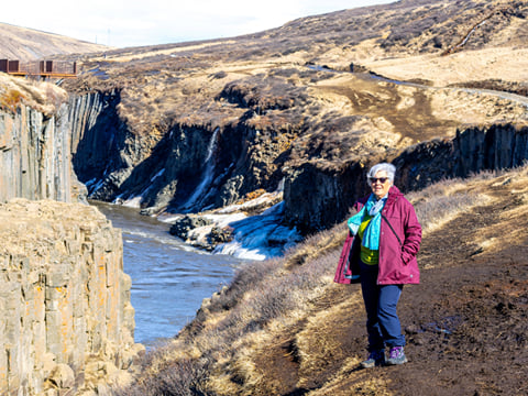 Reflections ripple in the turquoise waters beneath ancient basalt walls.