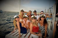 Dance the evening away with new friends as the golden light of sunset illuminates the lively resort skyline on your iconic Los Cabos catamaran cruise!