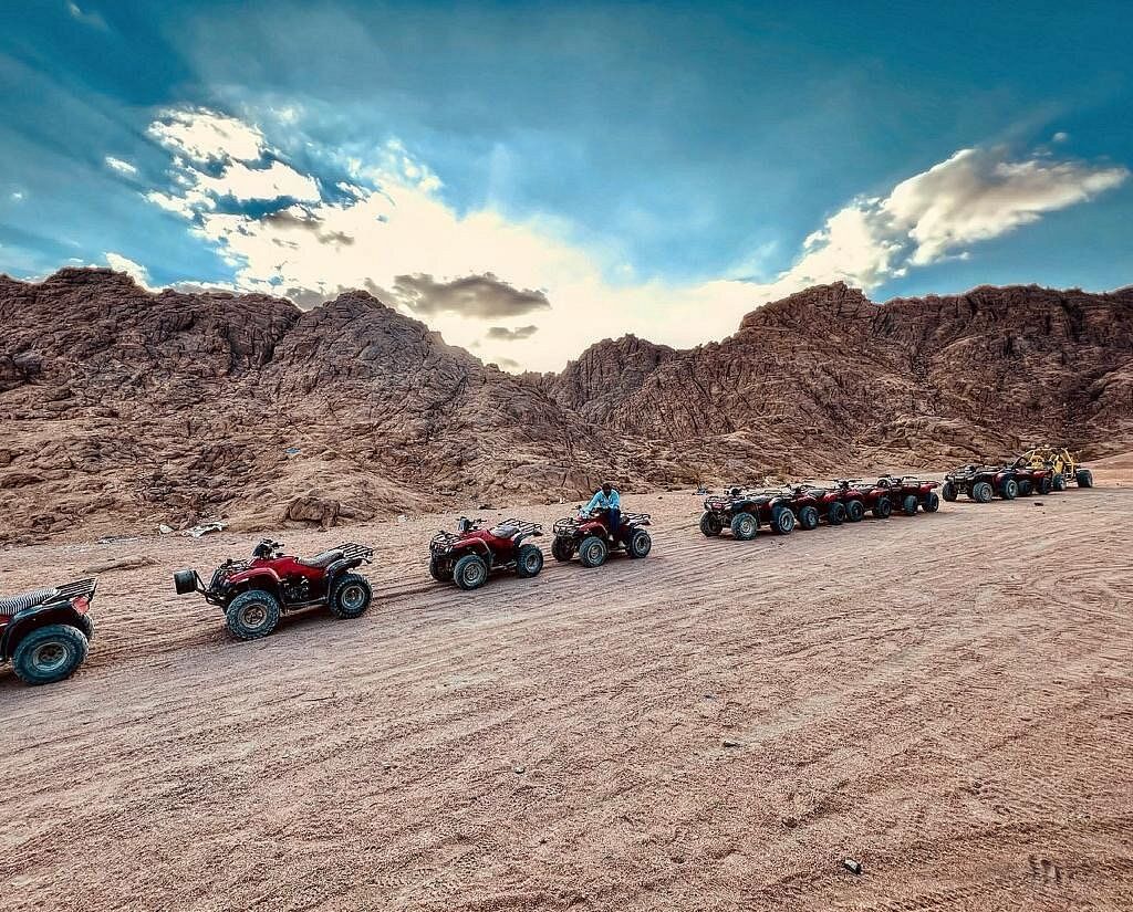Quad bikes awaiting customers at sunset.