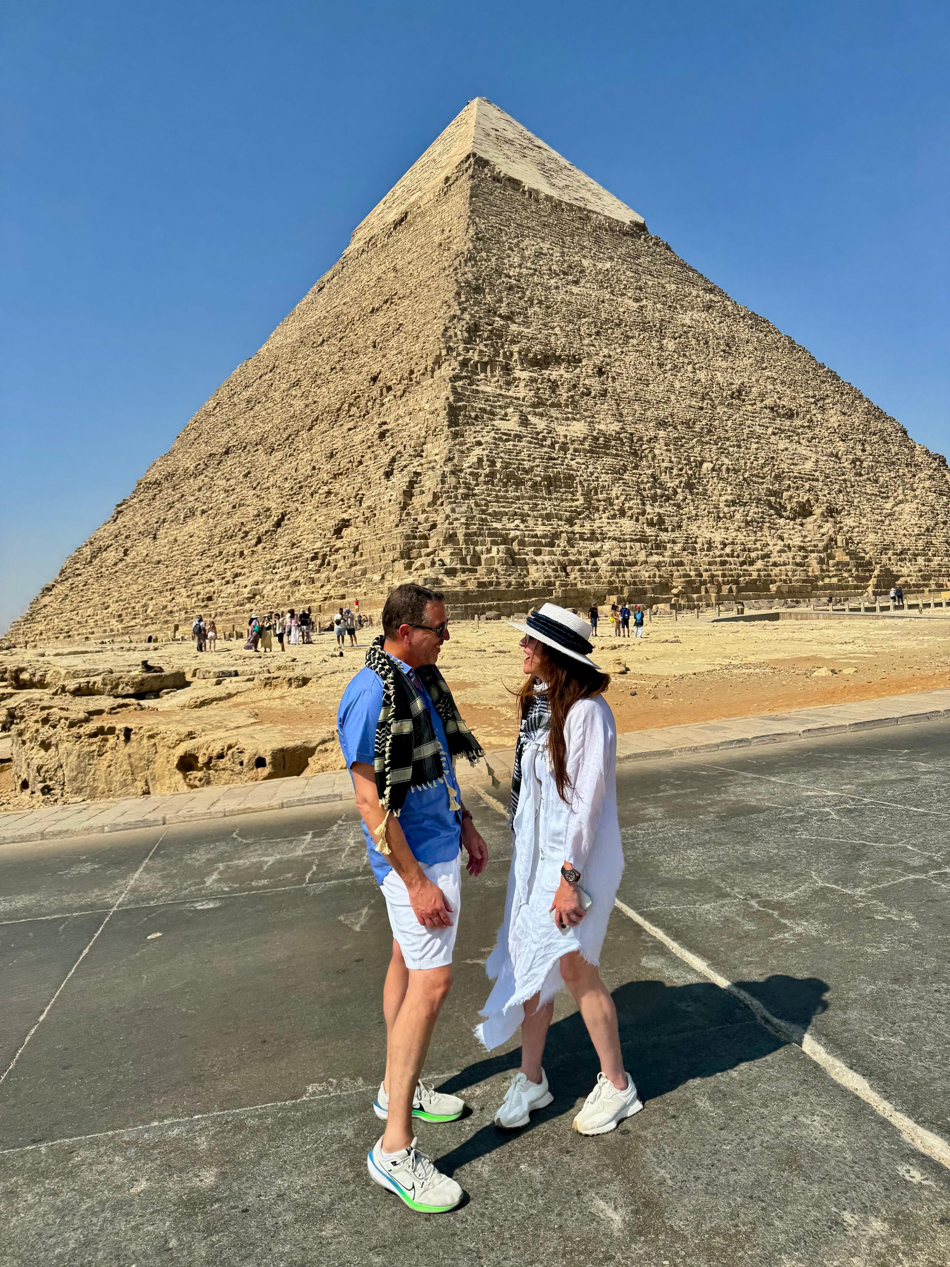 Couples posing at the Pyramid of Khafre during an Egypt honeymoon package.