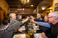 A group of Guests doing the cheers gesture