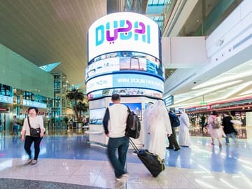 Travelers at Dubai International Airport.
