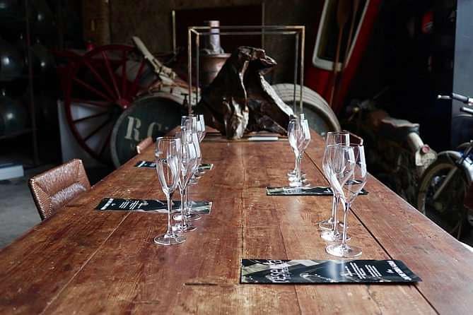 Champagne glasses are neatly arranged on a wooden table