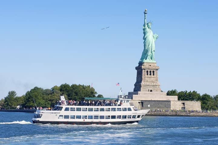 Passenger ferry cruising past the Statue of Liberty on New York Harbor