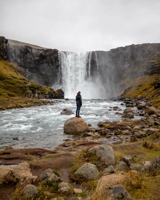 A traveller stranding at the bottom of the Gulufoss Waterfall