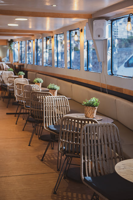 Window-side seating inside the half-day cruise boat