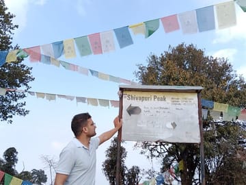 At top of the Shivapuri Peak at altitude of 2732 meters from sea level.