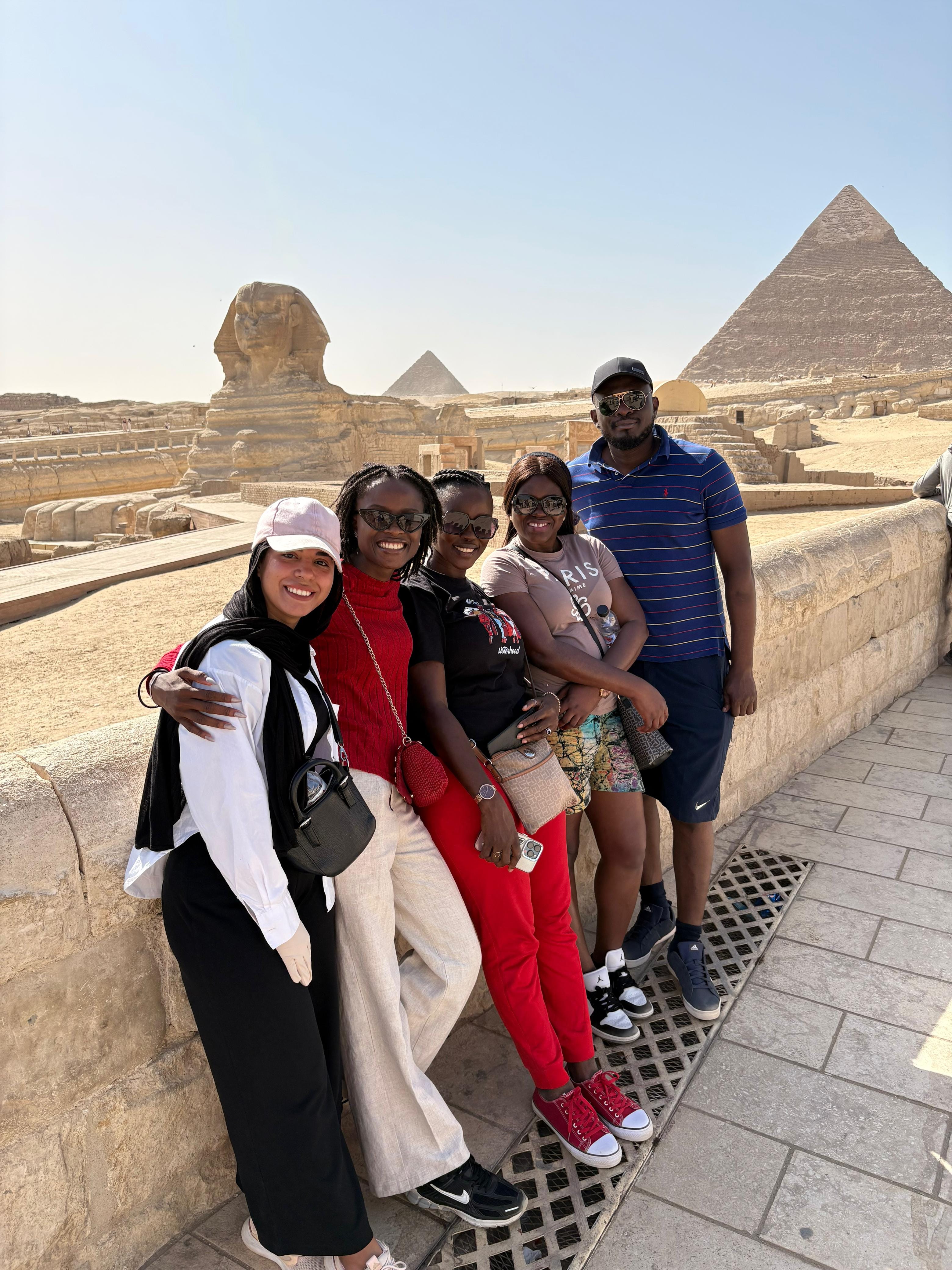 Family photo in front of the Sphinx on an Egypt cultural heritage tour