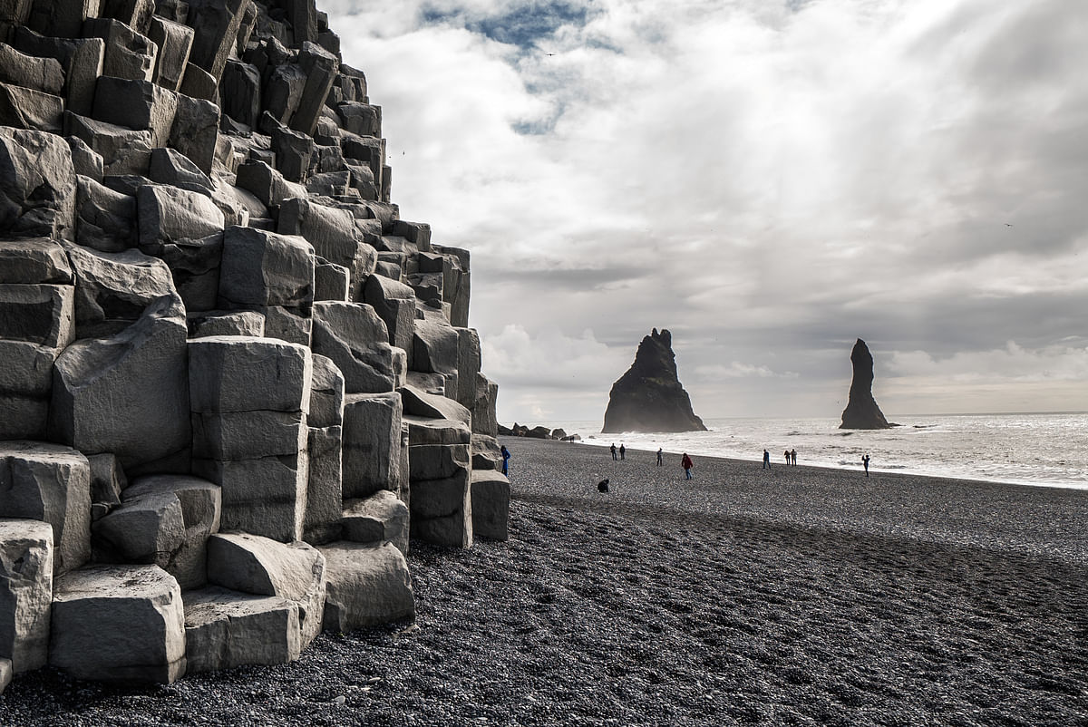 Black basalt sand and basalt columns at beautiful Reynisfjara beach