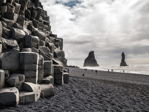 Black basalt sand and basalt columns at beautiful Reynisfjara beach