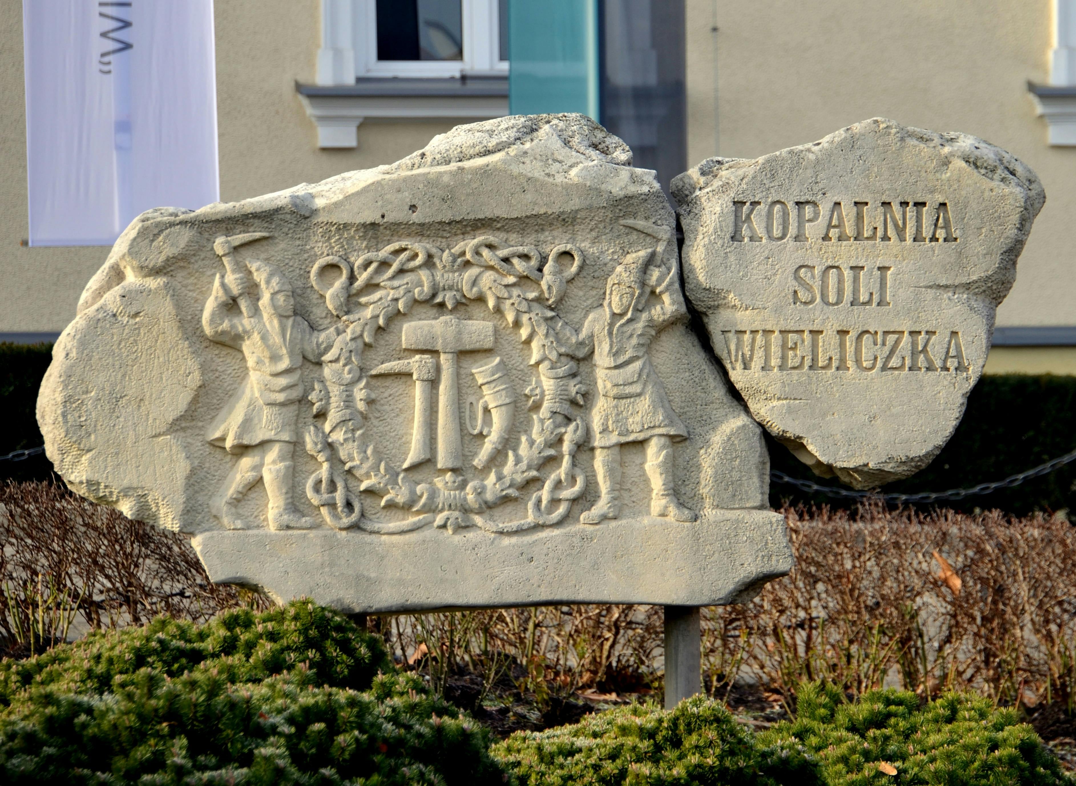 Stone monument sign reading Kopalnia Soli Wieliczka at the entrance to Wieliczka Salt Mine
