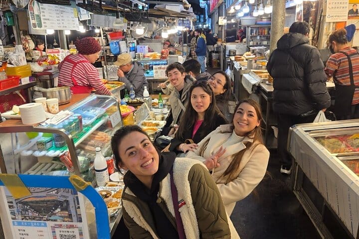 Experience authentic Korean street food at Gwangjang Market —A vendor at Gwangjang Market selling traditional Korean street food such as pancakes and seafood.