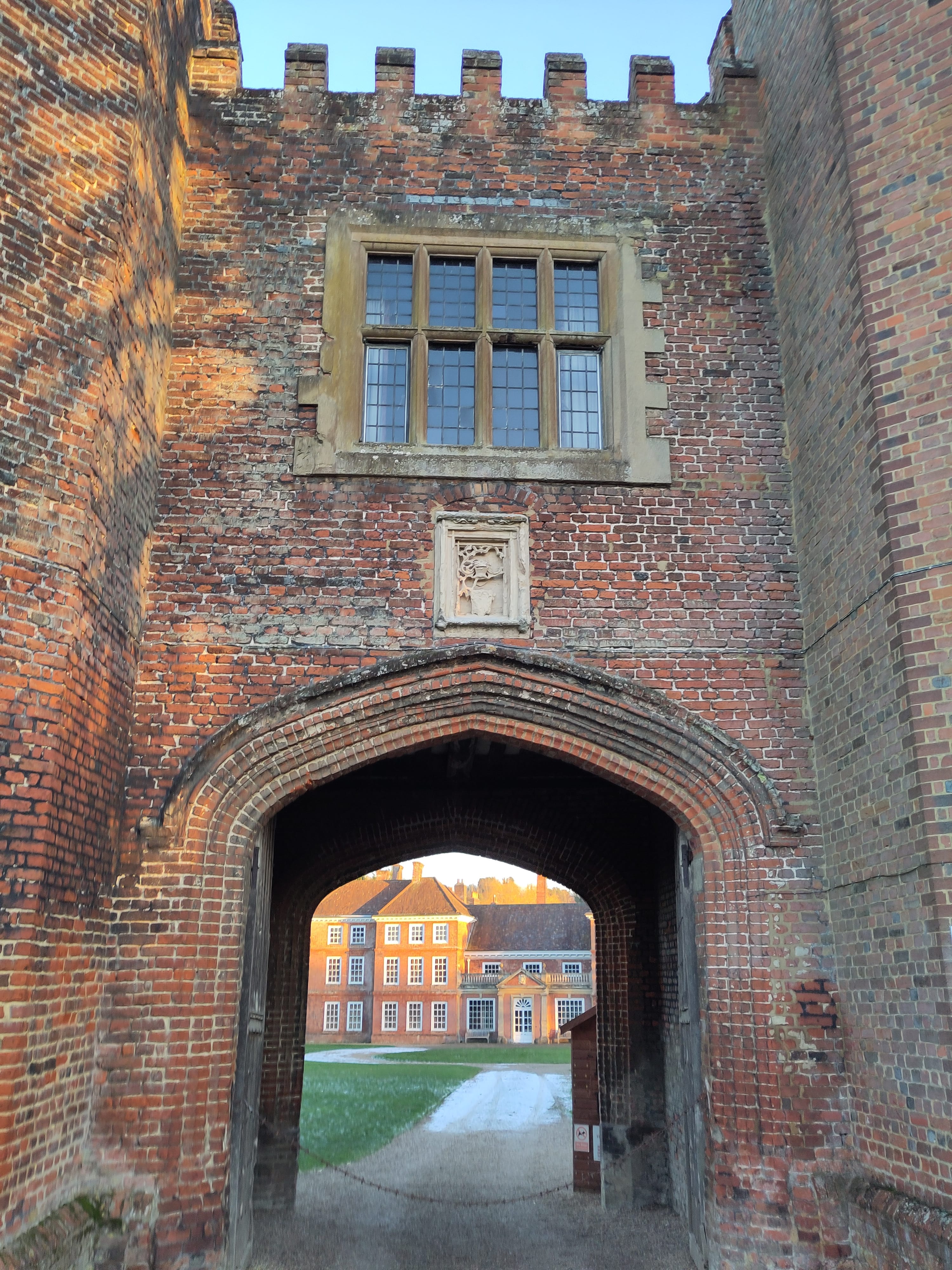 A tudor gatehouse with a house in the background