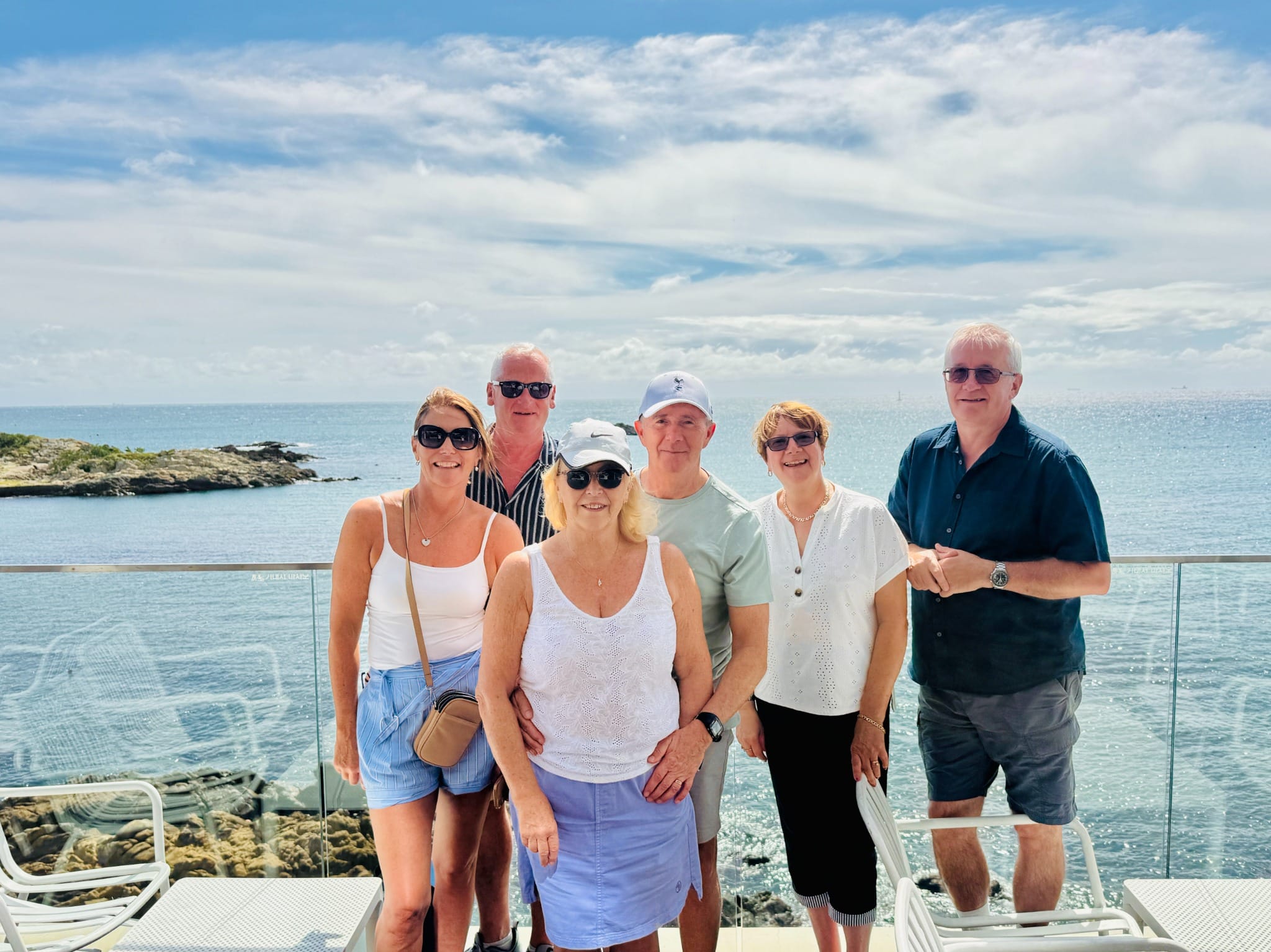 Visitors at a seaside café with panoramic ocean views