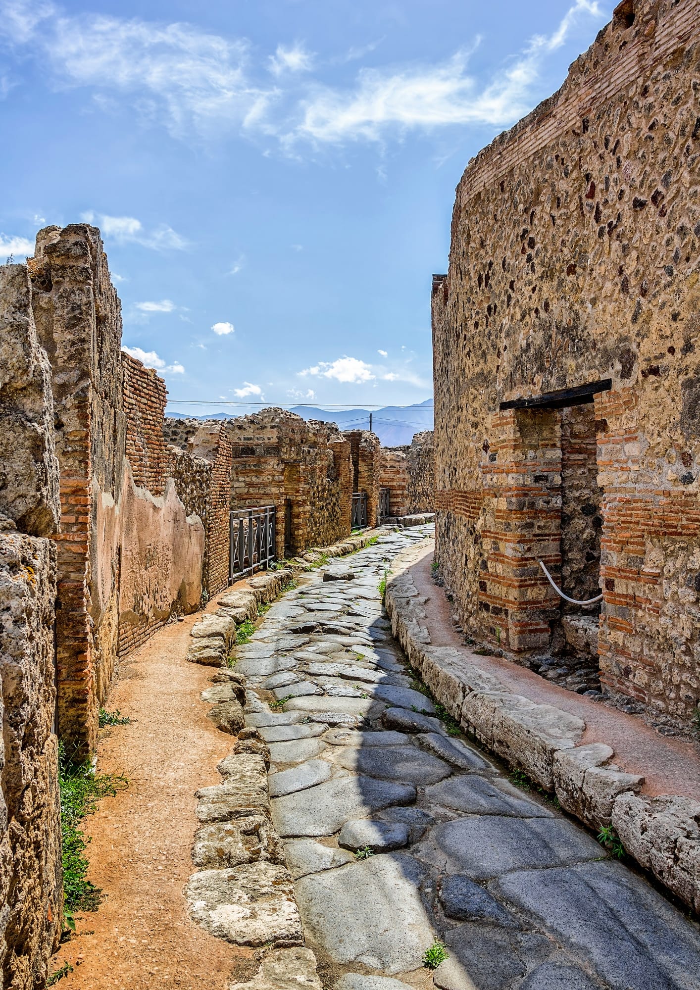 Walk the preserved streets of ancient Pompeii, with houses, frescoes and forums frozen in time on your day trip from Rome.