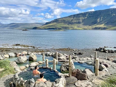 People relaxing in the hot geothermal waters at Hvammsvik