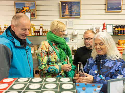 A tour Group browsing through a local speciality store in downtown Reykjavik.
