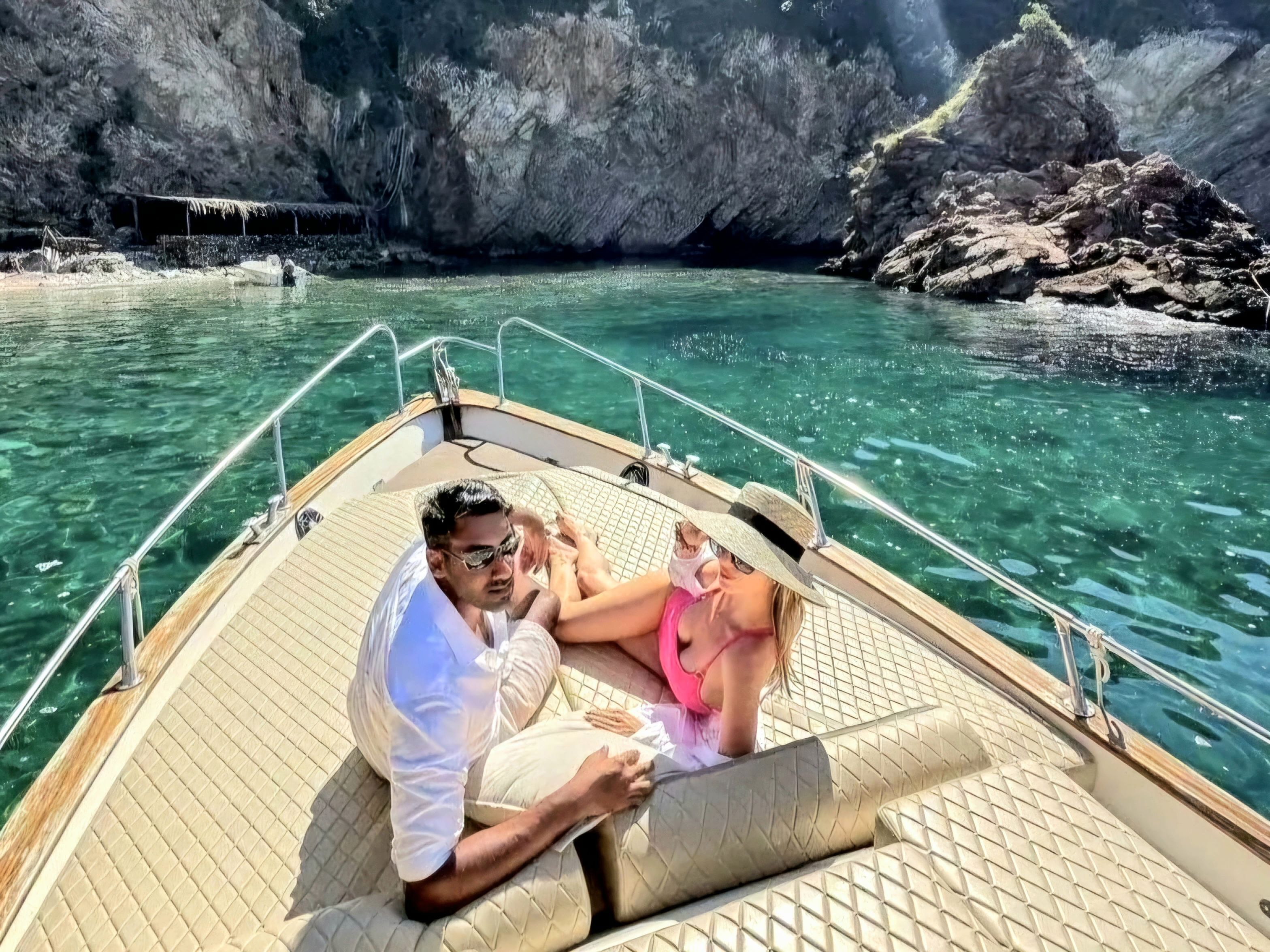 Guests relaxing on the boat deck, enjoying the sun and stunning coastal views.