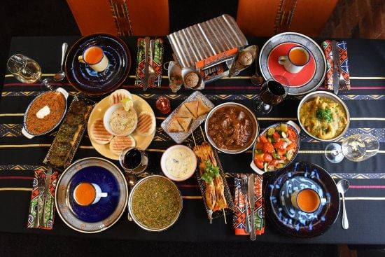 Selection of sharing dishes (curry, salad, skewers, soup) in the 14-dish tasting menu at Gold Restaurant, Cape Town.