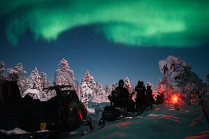 Northern lights by snowmobile