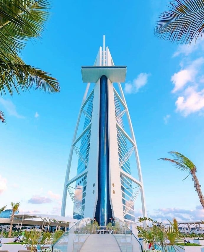 "Breathtaking exterior view of the Burj Al Arab under the Dubai skyline."