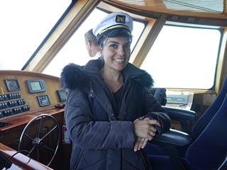 A staff member on board a whale watching vessel