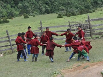 Dressed in their traditional costume, young students of Merak Village playing during the school break.