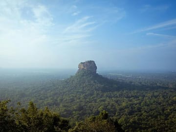 Climb the UNESCO-listed Sigiriya Rock Fortress and explore ancient frescoes and palace ruins with stunning views over Sri Lanka’s central plains.