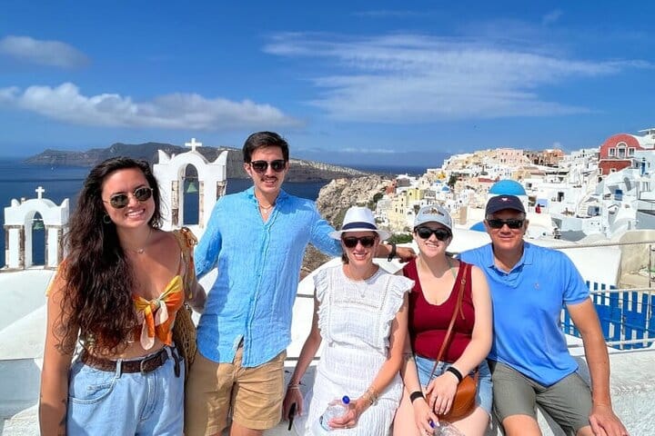 In front of the iconic blue domes of Oia