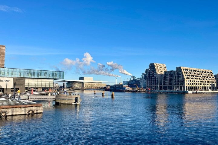 a beautiful view of Copenhagens harbour with a view of the Opera House, Paper island, and Skuespillerhuset 