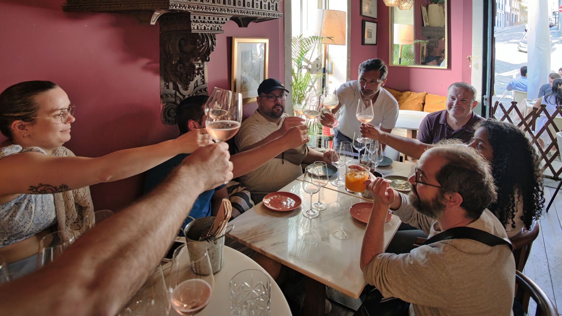 Small group toasting with wine glasses during a wine tasting and Fado experience in Porto