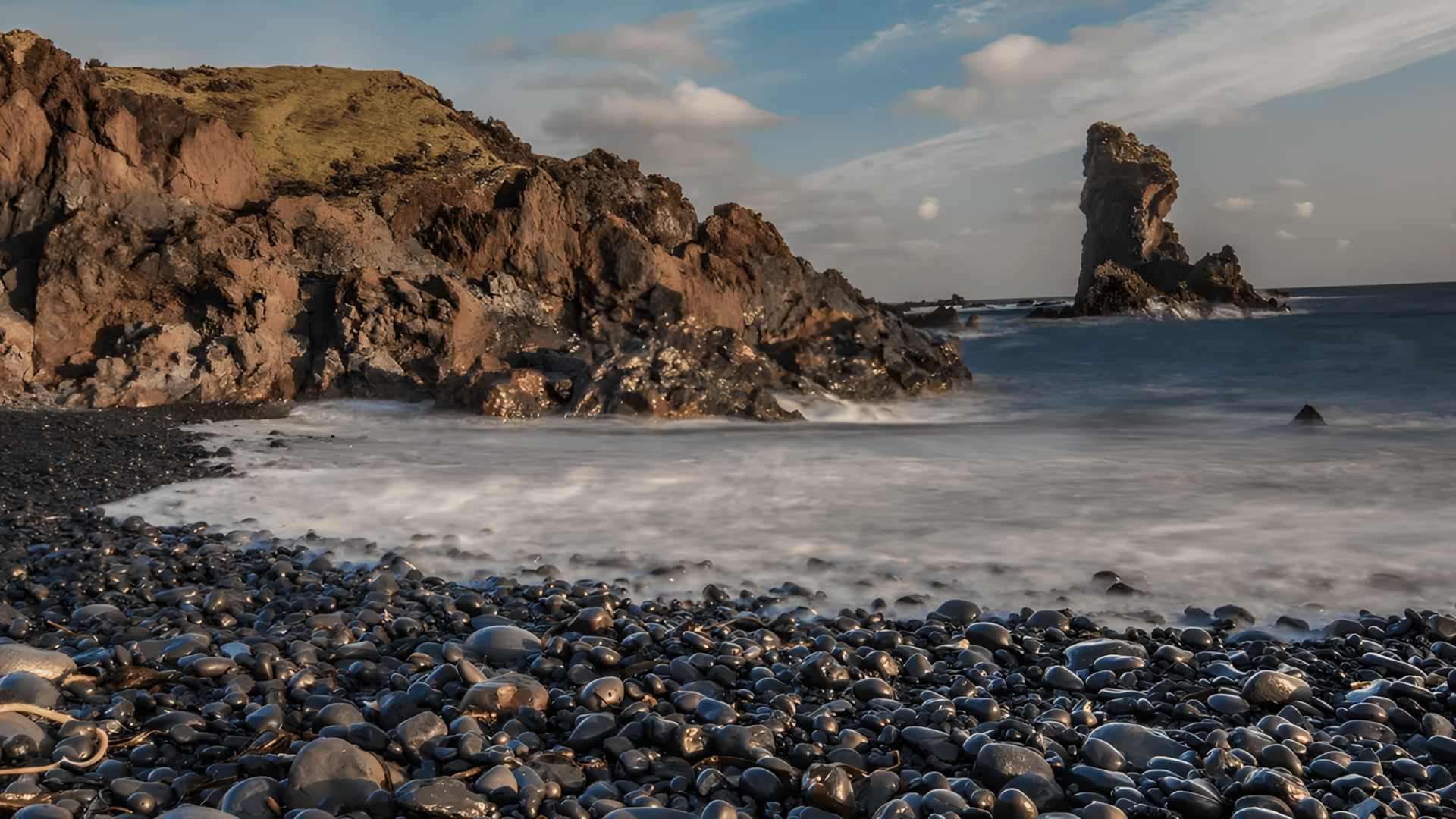 A black beach full of smooth pebbles