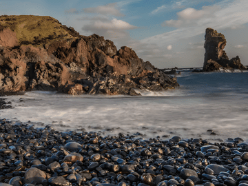 Explore the hauntingly beautiful black pebble beach, filled with lava rock formations and the remnants of a shipwreck