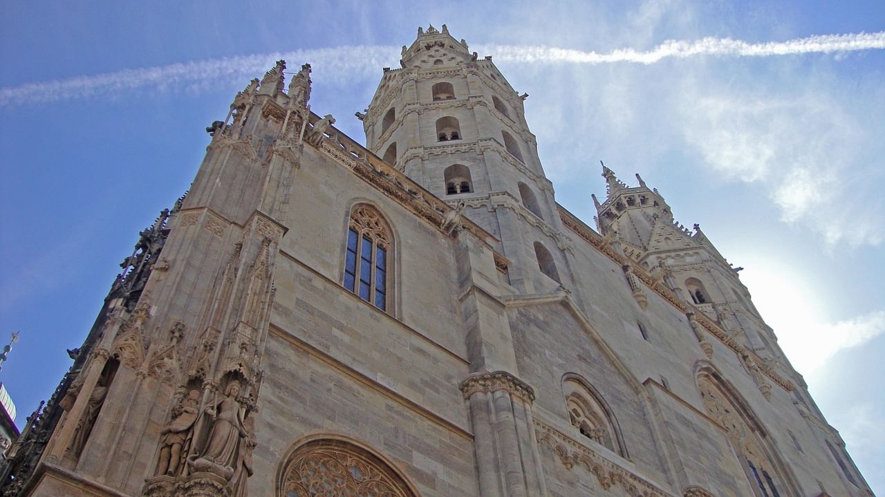 Gothic tower of St. Stephen’s Cathedral against blue sky.