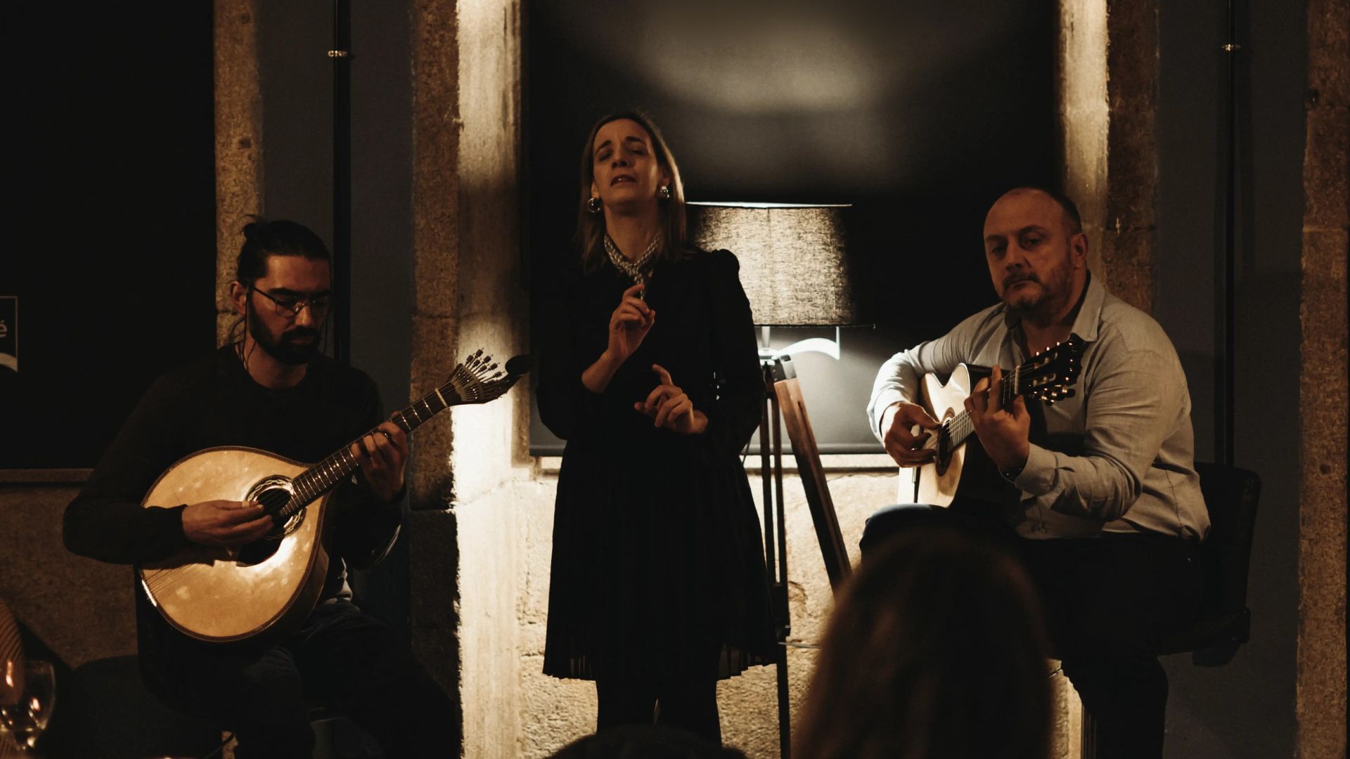 Fado trio with vocalist, Portuguese guitar, and classical guitar performing live in Porto