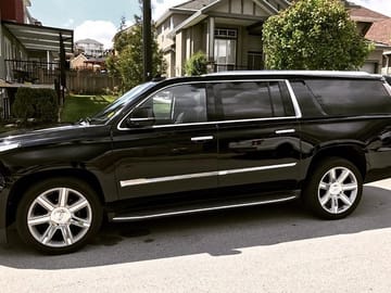 Black SUV, perfect for 4 guests with 6 suitcases and 4 carry on.