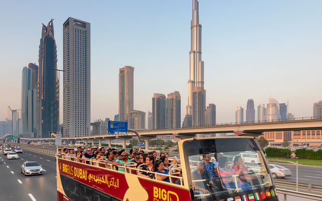 "A group of tourists takes in the sights of Dubai from the Big Bus, making their visit a memorable and enjoyable experience."