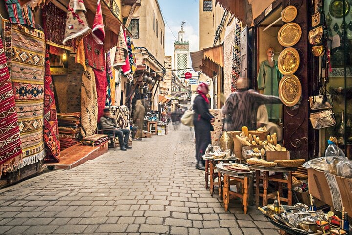 Lively streets of the souks of the medina of Fez, lined with Moroccan craft shops, traditional carpets and copper objects, in the heart of a UNESCO World Heritage district.