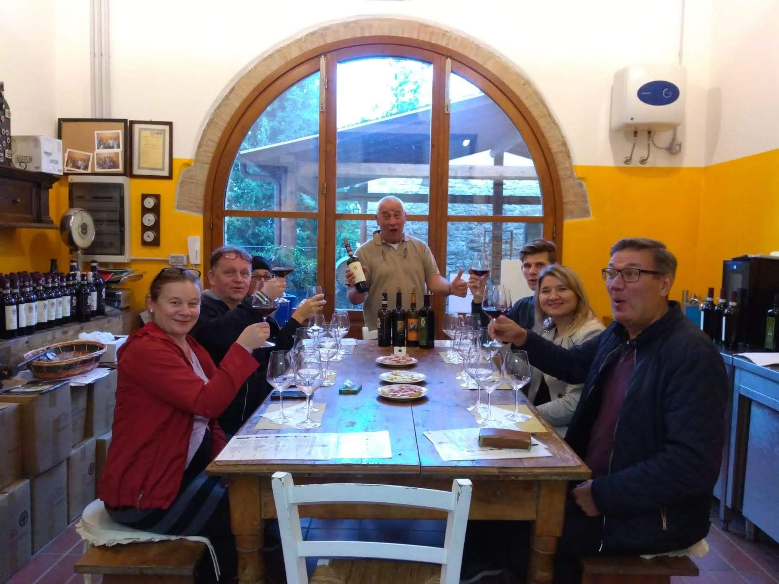 Customers enjoying a wine tasting of typical tuscan wine