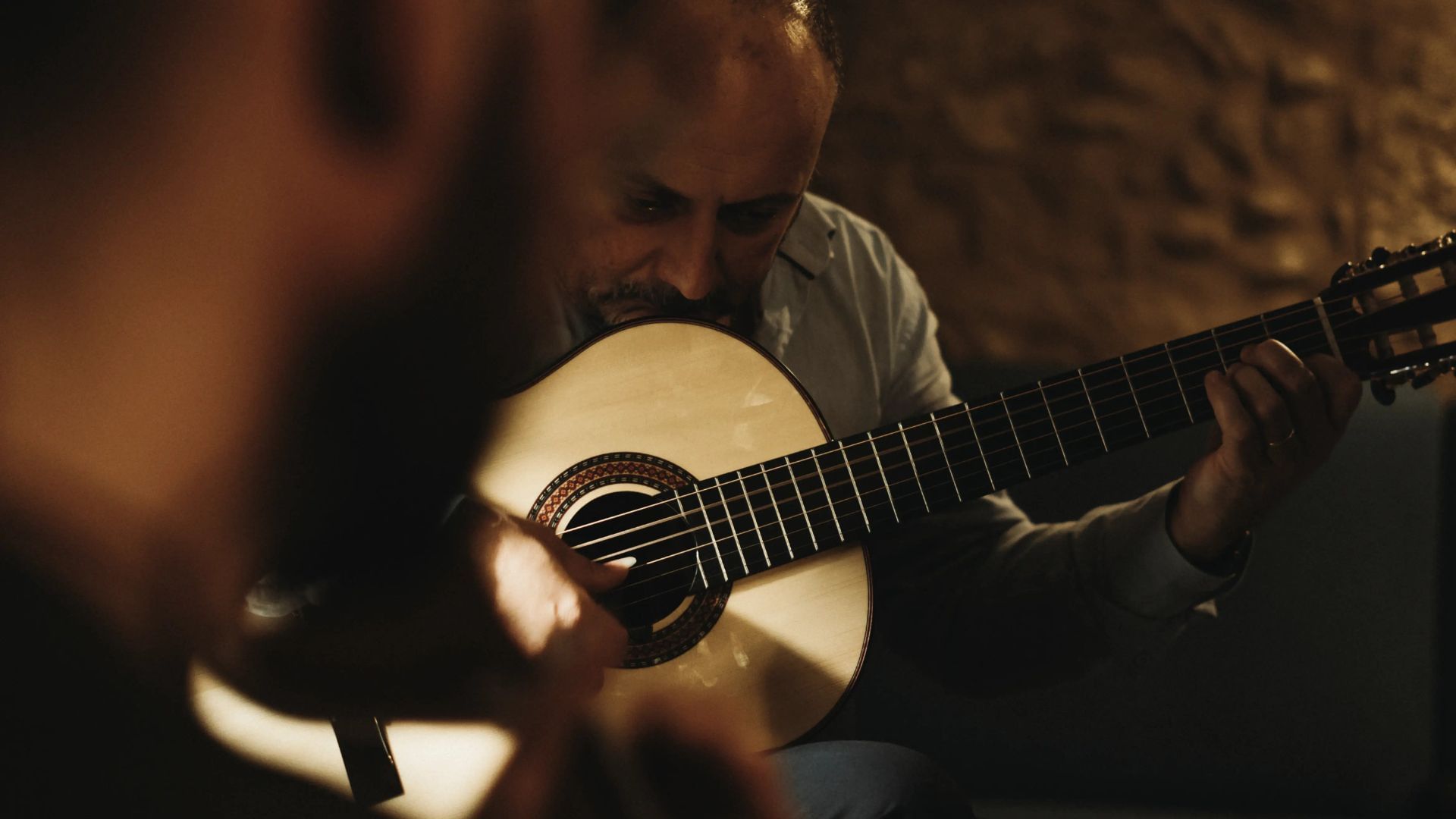 Classical guitar player captured during a live Fado concert in Porto
