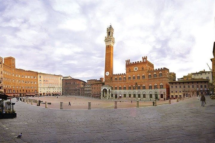 Wide view of the famous Piazza del Campo with the Palazzo Pubblico, seat of the city hall