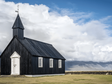 Stop at the striking black church of Búðir, set in a lava field with a glacier backdrop