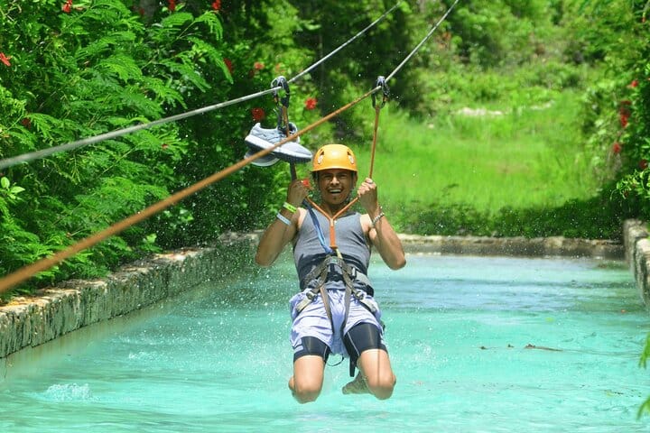 Elevate your adventure! Fly like a bird above the lush jungle and crystalline waters on Punta Cana's ultimate zipline experience.