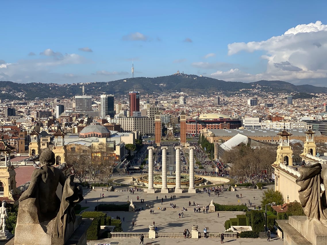 View from Montjuic hill over Barcelona in the direction of Plaça Espanya. You overlook the city with another mountain range in the back.