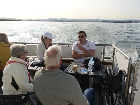 People sitting on deck of the Amelia Rose yacht